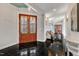 Foyer with tile flooring, double doors and wall hooks for coats and bags at 1126 Trailwood Dr, Raleigh, NC 27606