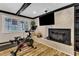 Home gym area with a fireplace, television, and exercise equipment at 1126 Trailwood Dr, Raleigh, NC 27606