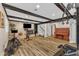 Spacious gym area featuring wood-look flooring, black accent beams, and home gym equipment at 1126 Trailwood Dr, Raleigh, NC 27606