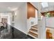 Hallway with staircase and view of the foyer with double doors at 1126 Trailwood Dr, Raleigh, NC 27606