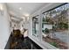 Bright hallway with polished floors, bench seat and large window view of exterior at 1126 Trailwood Dr, Raleigh, NC 27606