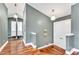Hallway leads to the bathroom and features hardwood floors, neutral paint, and stylish lighting at 1126 Trailwood Dr, Raleigh, NC 27606