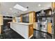 Modern kitchen features stainless steel appliances, granite countertops, an island, and a skylight at 1126 Trailwood Dr, Raleigh, NC 27606