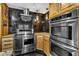Close-up shot of the kitchen with stainless steel appliances and black tiled walls at 1126 Trailwood Dr, Raleigh, NC 27606