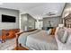 Spacious main bedroom with hardwood floors, en suite bathroom, and a wall-mounted television at 1126 Trailwood Dr, Raleigh, NC 27606
