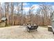 Stamped concrete patio with outdoor seating and mature trees, creating a private and relaxing outdoor space at 1126 Trailwood Dr, Raleigh, NC 27606
