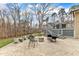 Stamped concrete patio features an outdoor fireplace, potted plants, and a charming deck with seating at 1126 Trailwood Dr, Raleigh, NC 27606