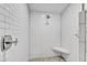 Walk-in shower featuring white subway tile, mosaic tile floor, and modern fixtures at 1126 Trailwood Dr, Raleigh, NC 27606