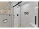 Walk-in shower with white subway tile, a glass door, and black accents at 1126 Trailwood Dr, Raleigh, NC 27606