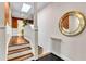 Staircase with wood treads and a gold-framed mirror at 1126 Trailwood Dr, Raleigh, NC 27606