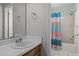 Clean bathroom with tub/shower combo and patterned shower curtain at 1322 Cedar Branch Ct, Wake Forest, NC 27587