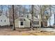 Cute yellow house with wood siding, a white porch, and mature trees surrounding the property at 1322 Cedar Branch Ct, Wake Forest, NC 27587