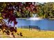 Scenic lake view with a tranquil fountain and park bench at 22 Shay St, Angier, NC 27501