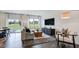 Open living space with large windows, hardwood floors, and backyard access at 22 Shay St, Angier, NC 27501