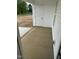 Covered back porch with white siding and door overlooking the backyard at 233 N Movado Trl, Kenly, NC 27542