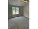 Carpeted bedroom with a ceiling fan, window with natural light, and neutral colored walls at 233 N Movado Trl, Kenly, NC 27542