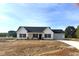 Charming single-story home with a white exterior, black shutters, and a two-car garage at 233 N Movado Trl, Kenly, NC 27542