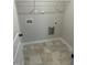 Laundry room with tile flooring, washer and dryer hookups, and wire shelving at 233 N Movado Trl, Kenly, NC 27542