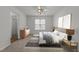 Bright bedroom featuring neutral walls, plush carpeting, and natural light streaming through the window at 2332 Turtle Point Dr, Raleigh, NC 27604