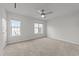 Empty bedroom featuring soft carpet, ceiling fan and bright natural light at 2332 Turtle Point Dr, Raleigh, NC 27604