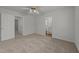 Neutral bedroom featuring soft carpet, ceiling fan and view into the bathroom at 2332 Turtle Point Dr, Raleigh, NC 27604