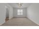 Empty bedroom with neutral walls, plush carpeting, ceiling fan and a bright window at 2332 Turtle Point Dr, Raleigh, NC 27604
