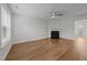 Inviting living room featuring light wood floors and a cozy fireplace, ready for your personal touch at 2332 Turtle Point Dr, Raleigh, NC 27604
