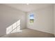 Bright bedroom with carpeted floor and a window offering a view of the outdoors at 264 Hawksmoore Ln, Lillington, NC 27546