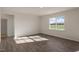 Bright bedroom with large window and wood-look flooring at 264 Hawksmoore Ln, Lillington, NC 27546