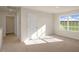 Upstairs bedroom with plush carpeting and large window at 264 Hawksmoore Ln, Lillington, NC 27546