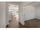 Hardwood-floored hallway showcasing a staircase and access to rooms at 264 Hawksmoore Ln, Lillington, NC 27546