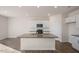 Island kitchen with granite countertops, stainless steel appliances, and white cabinets at 264 Hawksmoore Ln, Lillington, NC 27546