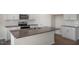 Granite kitchen island with sink, offering ample workspace and storage at 264 Hawksmoore Ln, Lillington, NC 27546