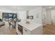 Open concept kitchen with island and living area view at 29 Enterprise St # 108, Raleigh, NC 27607