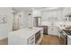 Modern white kitchen with stainless steel appliances and island at 29 Enterprise St # 108, Raleigh, NC 27607