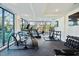 Bright gym with modern exercise equipment, treadmills, weights, and large windows with neighborhood views at 29 Enterprise St # 108, Raleigh, NC 27607