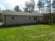 Nice home exterior featuring a wooden deck and a lush green lawn and ample parking at 3050 Bennett Siler City Rd, Bennett, NC 27208