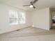 Bright bedroom with two windows and ceiling fan at 3050 Bennett Siler City Rd, Bennett, NC 27208