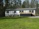 Charming single-story home featuring a lovely front porch and well-maintained lawn and blue shutters at 3050 Bennett Siler City Rd, Bennett, NC 27208