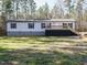 Charming single-story home featuring a large front porch, neutral siding, and complementary dark blue shutters at 3050 Bennett Siler City Rd, Bennett, NC 27208