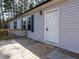 Front entrance of the home with a white door and wooden deck at 3050 Bennett Siler City Rd, Bennett, NC 27208