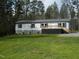 Charming single-story home featuring a lovely front porch and well-maintained lawn and blue shutters at 3050 Bennett Siler City Rd, Bennett, NC 27208