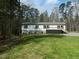 Charming single-story home featuring a lovely front porch and well-maintained lawn and blue shutters at 3050 Bennett Siler City Rd, Bennett, NC 27208
