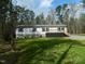 Charming single-story home featuring a lovely front porch and well-maintained lawn and blue shutters at 3050 Bennett Siler City Rd, Bennett, NC 27208