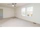 Living room with hardwood floors, two windows, and access to the kitchen at 3050 Bennett Siler City Rd, Bennett, NC 27208
