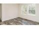 Spare bedroom with hardwood floors and two windows at 3050 Bennett Siler City Rd, Bennett, NC 27208