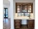 Close-up of the bar area highlighting custom cabinets, mirrored backsplash, and marble countertop at 3315 Hampton Rd, Raleigh, NC 27607