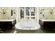 Modern bathroom with dual sinks, soaking tub, and view from the window at 3315 Hampton Rd, Raleigh, NC 27607
