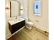 Powder room featuring a modern floating vanity with a stone countertop and dark wood base at 3315 Hampton Rd, Raleigh, NC 27607