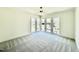 The bedroom is brightly lit from the large windows, and has gray carpet at 3315 Hampton Rd, Raleigh, NC 27607